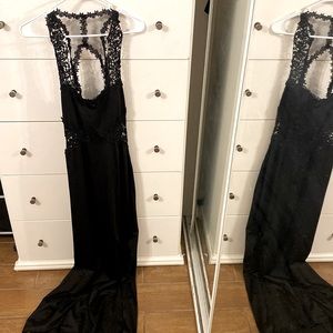 Laced, open back, black dress with a little train following behind